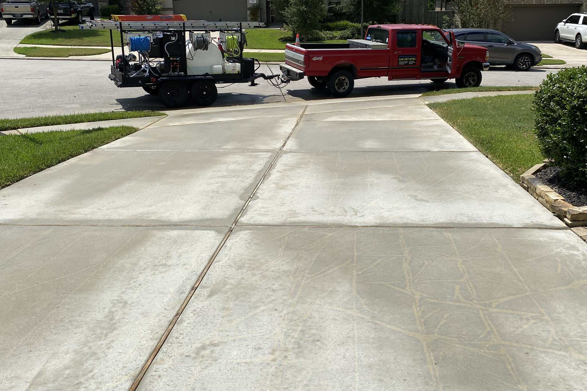 IMG_7244-2048X1365 Power washing driveway surface with professional equipment for deep cleaning.